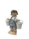 Boy standing with 2 buckets